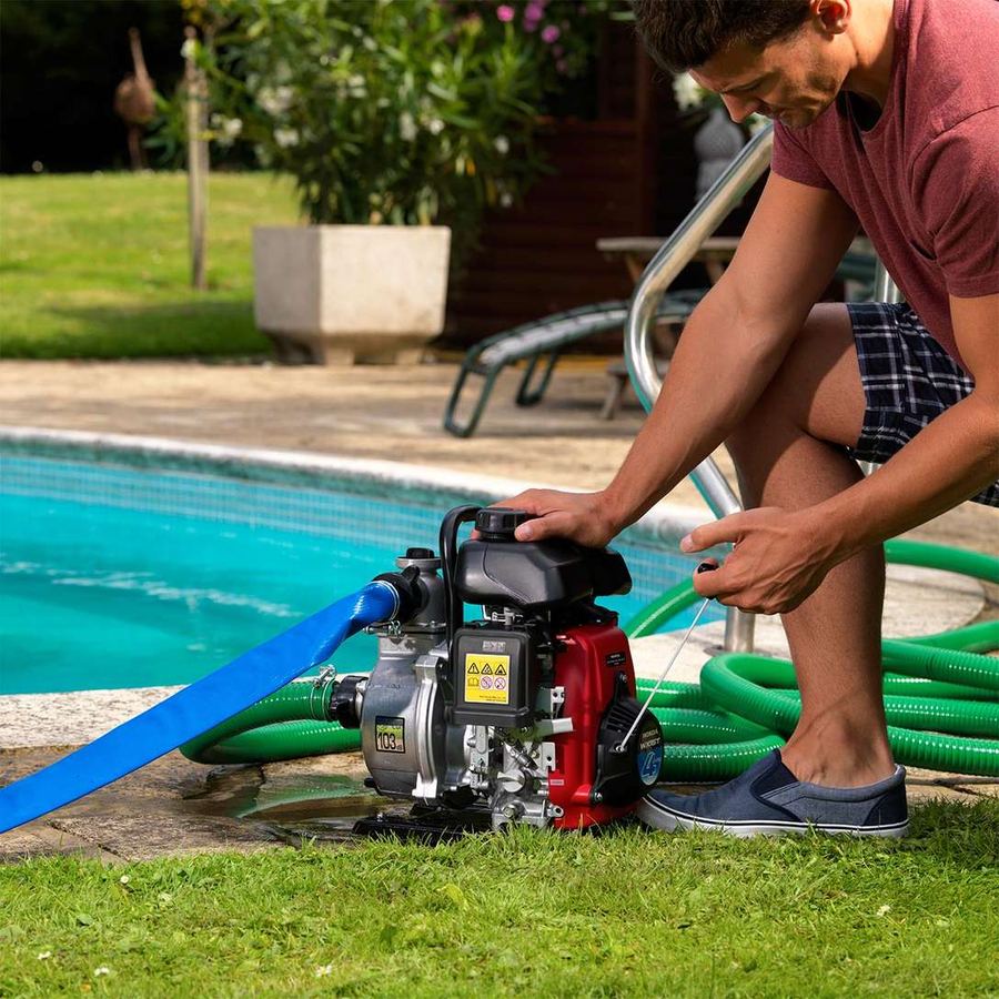 Honda WX lightweight pump draining a swimming pool
